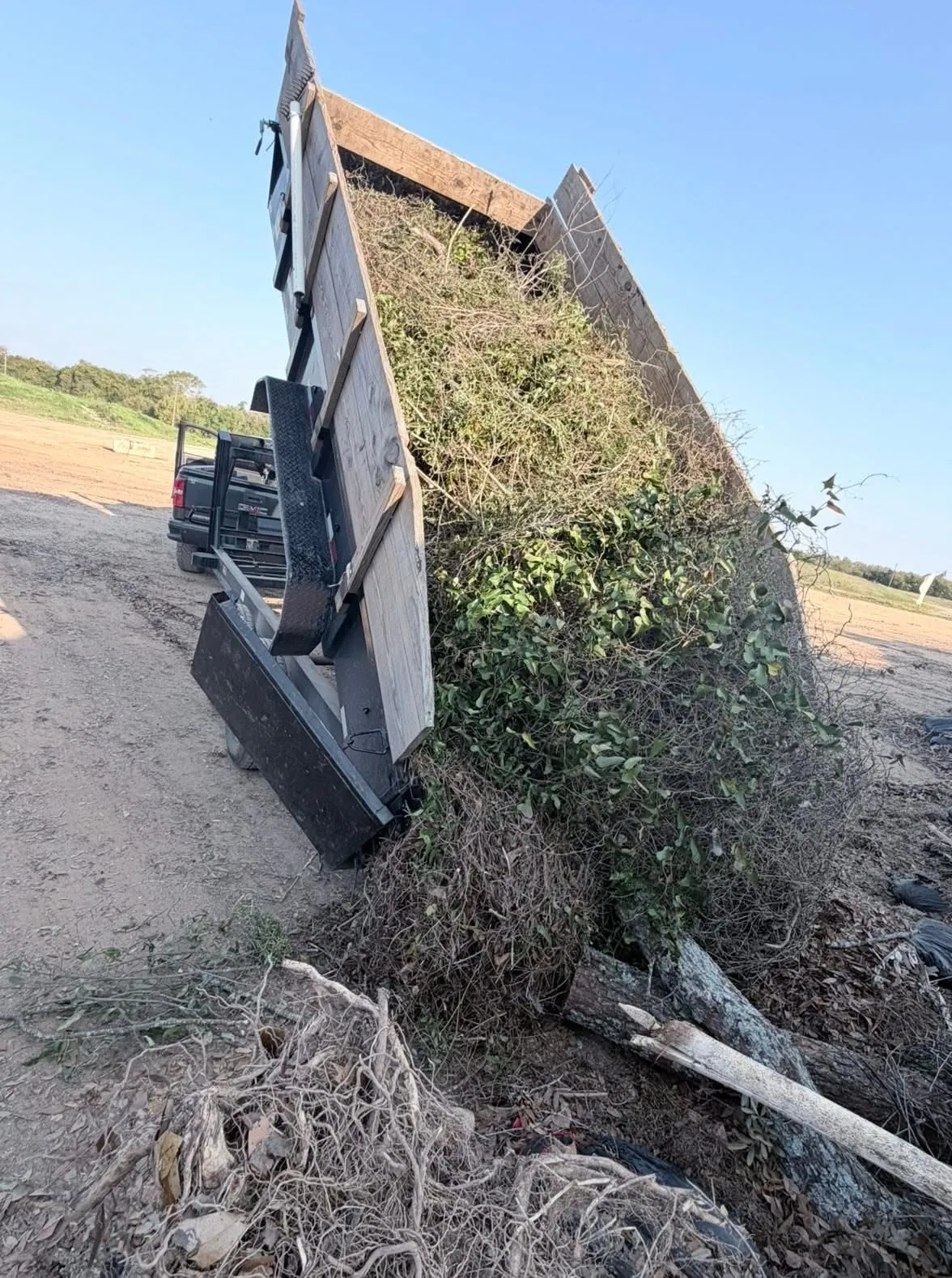 Yard debris being loaded into a dump trailer